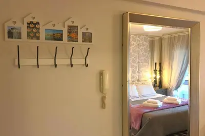 a bedroom with a bed and a mirror at Romantic Getaway Suite in Porto
