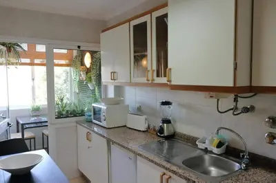 a kitchen with a sink and a counter top at Romantic Getaway Suite in Porto