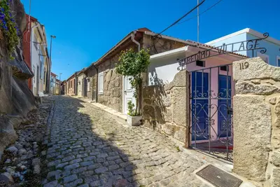 a cobblestone street in a village with buildings at Maredimo Village Casa 3 in Porto
