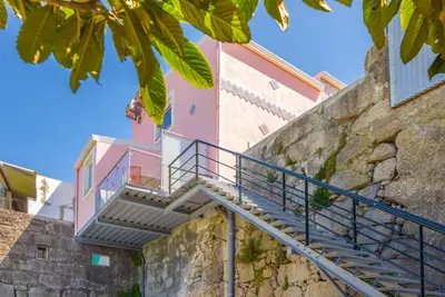 a staircase leading up to a pink building at Maredimo Village Casa 3 in Porto