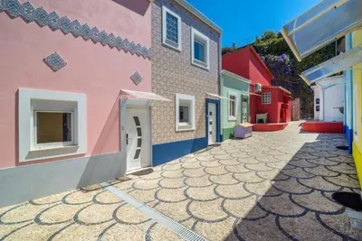 a row of colorful houses with a cobblestone street at Maredimo Village Casa 3 in Porto