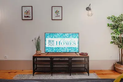 a living room with a table with a sign on it at Oporto Artist´s Loft in Porto