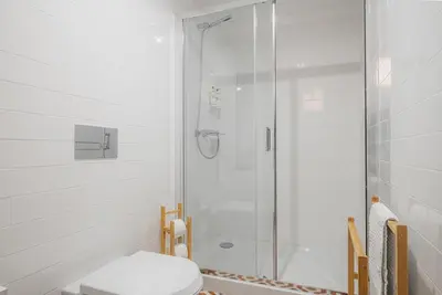 a shower with a glass door in a bathroom at Oporto Artist´s Loft in Porto