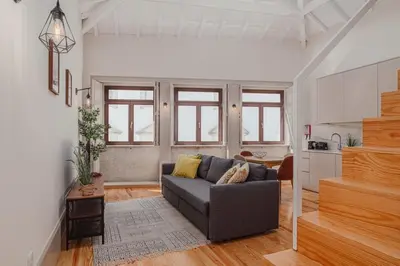 a living room with a couch and a kitchen at Oporto Artist´s Loft in Porto