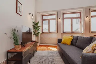 a living room with a couch and a tv at Oporto Artist´s Loft in Porto