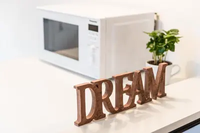 a white microwave and a sign that reads real at GuestReady - Three Mirrors in Porto