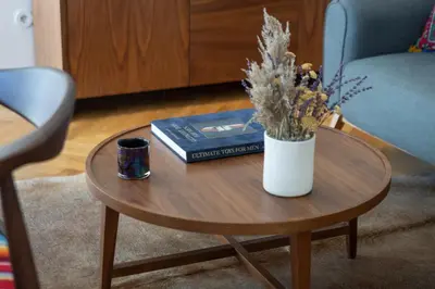 a coffee table with books and a vase with flowers on it at Best rooftop in Porto! in Porto