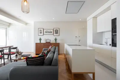 a kitchen and living room with a couch and a table at Best rooftop in Porto! in Porto