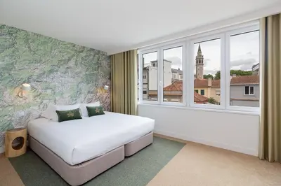 a bedroom with a white bed and a window at Casa de Arouca Porto Apartments in Porto