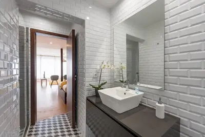 a bathroom with a white sink and a mirror at GuestReady - Hemisphere Apt in Porto