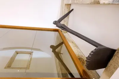 a large black pole on a wall next to a mirror at The Bitcoin Chapel Iconic Luxury Residence in Porto