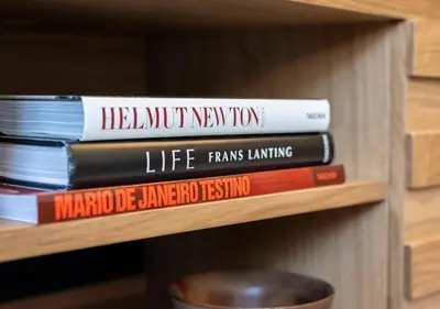 a stack of books sitting on a shelf at Mouzinho da Silveira Unique Apartments, by Oporto Collection in Porto