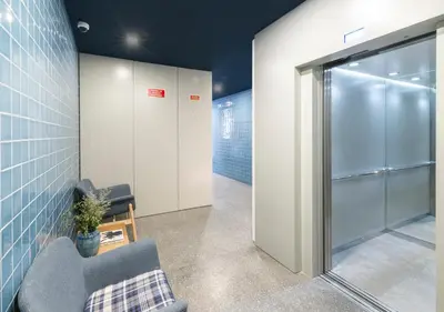 a room with a chair and a glass door at Mouzinho da Silveira Unique Apartments, by Oporto Collection in Porto