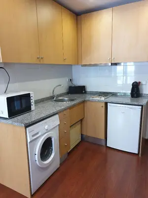 a kitchen with a washing machine and a sink at PORTO RICO STUDIOS in Porto
