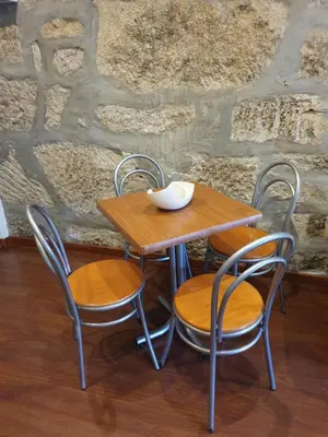 a wooden table with two chairs and a bowl on it at PORTO RICO STUDIOS in Porto