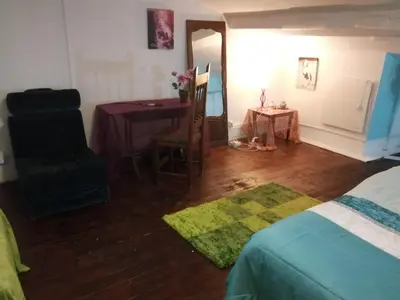 a bedroom with a bed and a table and a chair at AL- Almada 4 in Porto