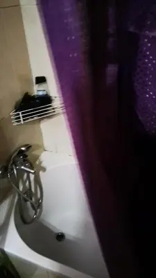 a bathroom with a sink and a purple shower curtain at AL- Almada 4 in Porto