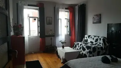 a living room with a couch and a chair at AL- Almada 4 in Porto