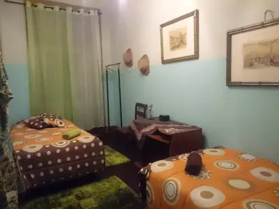 a room with two ottomans and a table and a window at AL-Almada-2 in Porto