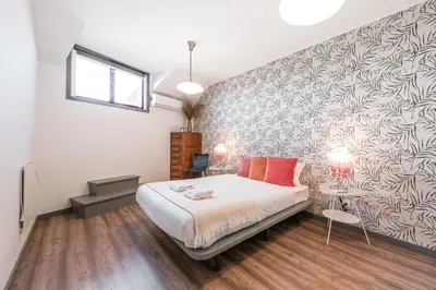 a bedroom with a bed and a wall at GuestReady - Red Stripes in Porto