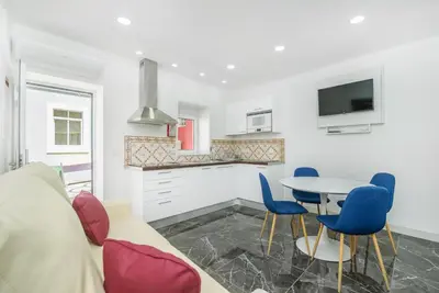 a living room with a couch and a table and chairs at Maredimo Village Casa 6 in Porto