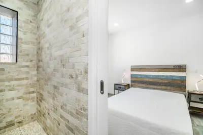 a bedroom with a bed and a brick wall at Maredimo Village Casa 6 in Porto