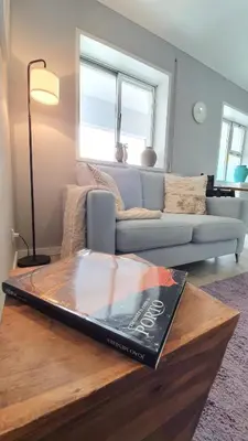 a book sitting on a coffee table in a living room at Gaiapart in Vila Nova de Gaia