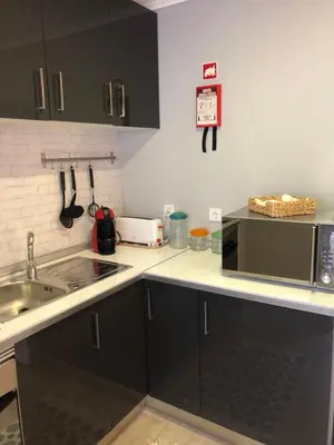 a kitchen with a sink and a microwave at Gaiapart in Vila Nova de Gaia