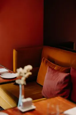 a table and chairs with a vase of flowers on it at Casa da Companhia Hotel & Spa, Vignette Collection by IHG in Porto