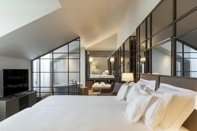 a bathroom with three sinks and mirrors at Casa da Companhia Hotel & Spa, Vignette Collection by IHG in Porto
