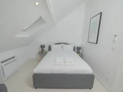 a white kitchen with a white table and chairs at OPORTO GUEST - Maia House in Porto