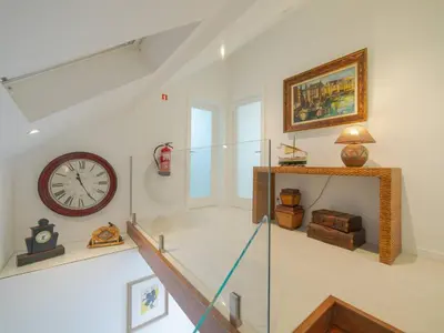a large kitchen with white cabinets and appliances at OPORTO GUEST - Maia House in Porto