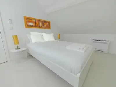 a white bedroom with a bed in a white room at OPORTO GUEST - Maia House in Porto