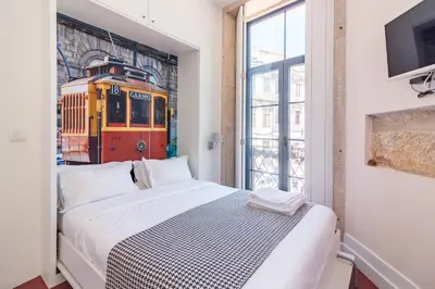 a bedroom with a bed and a train mural at ON Apartments - Center in Porto