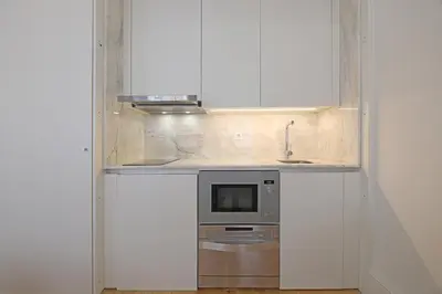 a kitchen with a sink and a microwave at FLH Porto Traditional Studio in Porto