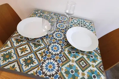 a table with two glasses on top of a tile floor at FLH Porto Traditional Studio in Porto