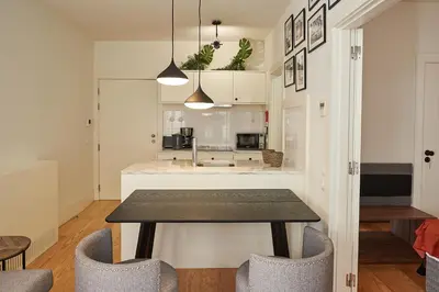 a kitchen and dining room with a table and chairs at BOUTIQUE Rentals-Flores Classic historical centre in Porto