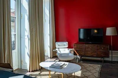 a bedroom with a large bed with two lamps at Almada 234 in Porto