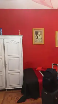 a red bedroom with a bed and a white door at AL-Pinheiro 62 in Porto