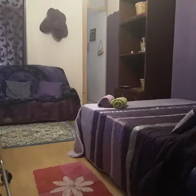 a room with a table and a purple wall at AL-Pinheiro 62 in Porto