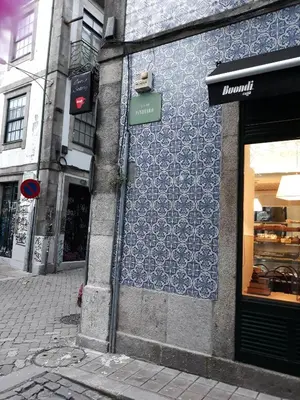 a bedroom with a bed and a stone wall at Al Pinheiro 66 in Porto