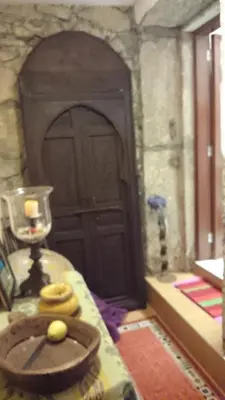 a bedroom with a red bed with a stone wall at Al Pinheiro 66 in Porto