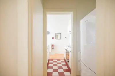 a hallway with a checkered floor in a kitchen at Oporto Flores Plaza by LovelyStay in Porto
