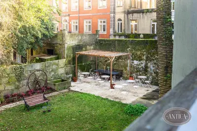 a garden with a table and chairs and a tent at Casa Antiga in Porto
