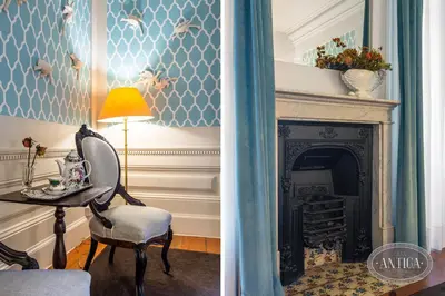 a living room with a table and a fireplace at Casa Antiga in Porto