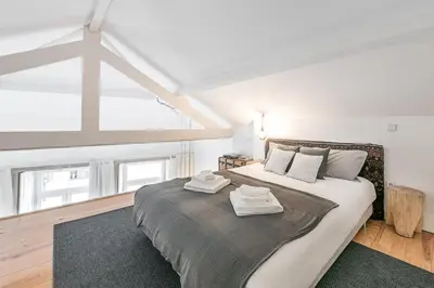 a bedroom with a large bed with towels on it at GuestReady - Cosy living in downtown in Porto