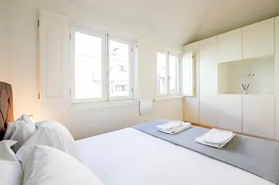 a bedroom with a bed with two towels on it at LovelyStay - Cozy 1BR in Santa Catarina w/ Balcony in Porto