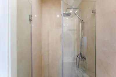 a shower with a glass door in a bathroom at LovelyStay - Cozy 1BR in Santa Catarina w/ Balcony in Porto