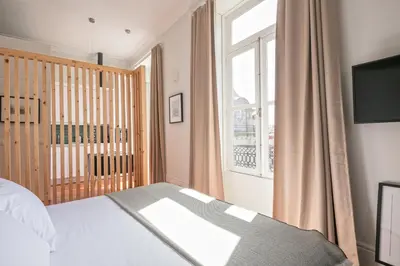 a bedroom with a bed and a window at Oportments - S.Bento in Porto