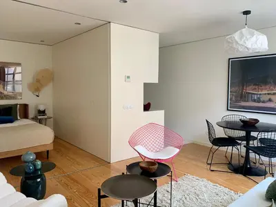 a living room with a bed and a table and chairs at Oporto Chic & Cozy - Santa Catarina in Porto